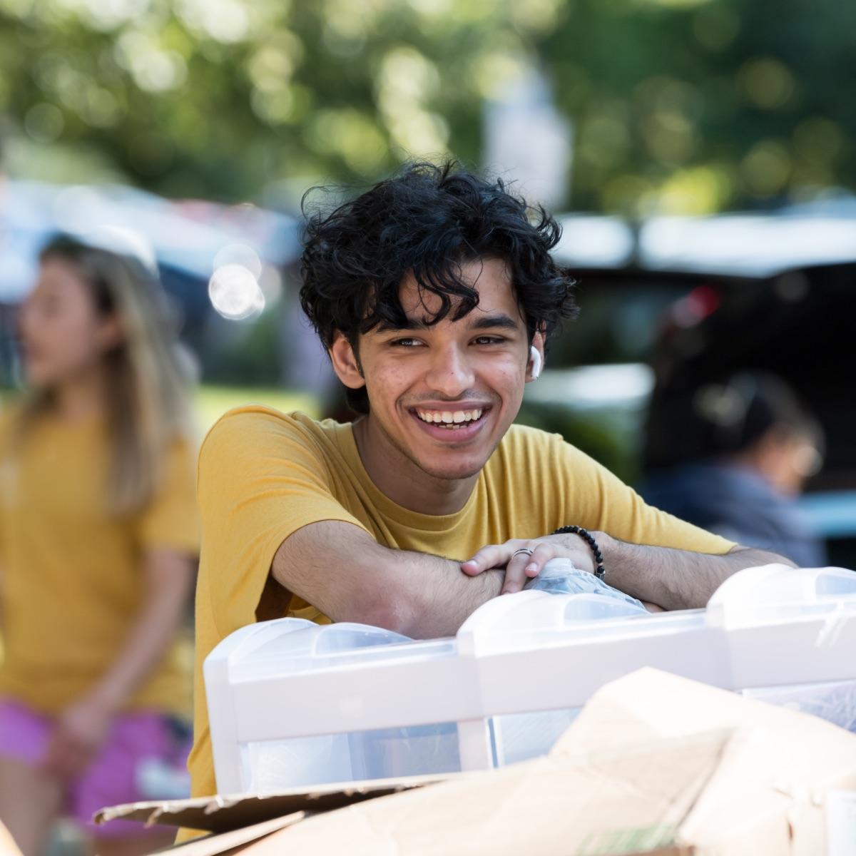 A student smiles during move-in day